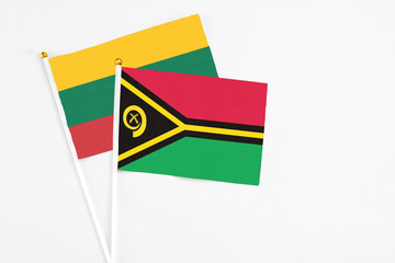 Vanuatu and Lithuania stick flags on white background. High quality fabric, miniature national...