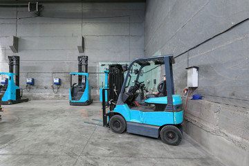 forklift charging in the warehouse © gluschenkoart