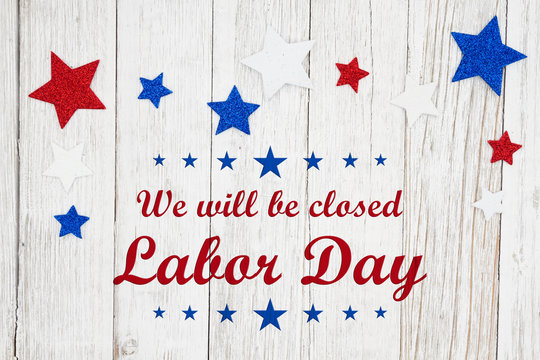 Closed Labor Day with red, white and blue stars on a weathered whitewash