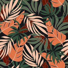 Fashionable seamless tropical pattern with beautiful plants and leaves on dark background. Printing and textiles.    Vector design. Jungle print. Floral background.  Exotic jungle wallpaper.