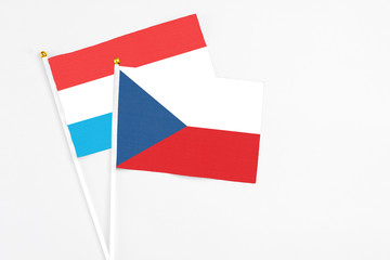 Czech Republic and Luxembourg stick flags on white background. High quality fabric, miniature national flag. Peaceful global concept.White floor for copy space.