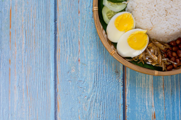 Nasi Lemak is commonly found food in Malaysia, Brunei and Singapore. It is an unofficial national food in Malaysia. Selective focus.