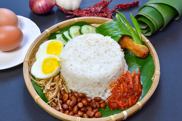 Nasi Lemak is commonly found food in Malaysia, Brunei and Singapore. It is an unofficial national food in Malaysia. Selective focus.