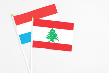 Lebanon and Luxembourg stick flags on white background. High quality fabric, miniature national...
