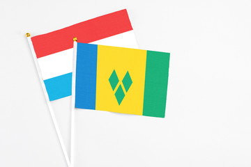 Saint Vincent And The Grenadines and Luxembourg stick flags on white background. High quality...