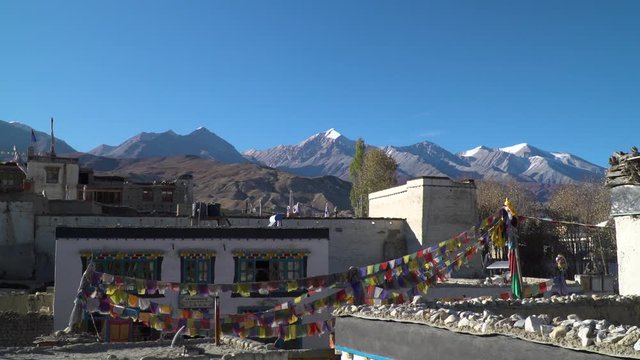 Hidden in the Himalaya mountains, an ancient village with prayer flags
