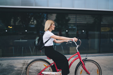 Fototapeta na wymiar Attractive woman riding bike on street