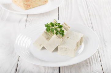 Soy Bean curd tofu on clay dish closeup. Non-dairy alternative substitute for cheese
