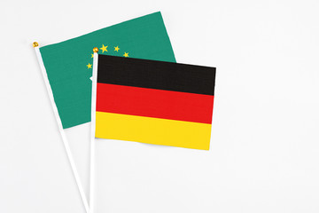 Germany and Macao stick flags on white background. High quality fabric, miniature national flag. Peaceful global concept.White floor for copy space.