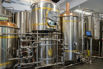 Stainless steel brewing tanks and equipment, iron reservoirs and pipes in modern beer factory