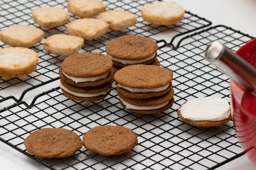 Gingerbread Cookies with Frosted Filling on a Cooling Rack