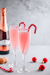Festive Christmas drink Peppermint Bark Mimosa cocktail with champagne or prosecco and candy cane