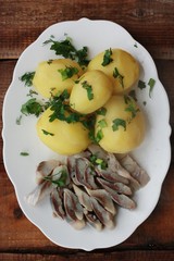 Delicious potatoes with dill and herring for dinner