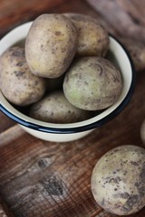 Fresh potatoes in a bowl on the table