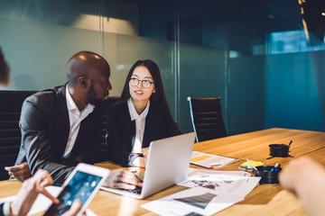 Multiracial man and woman coworking in office