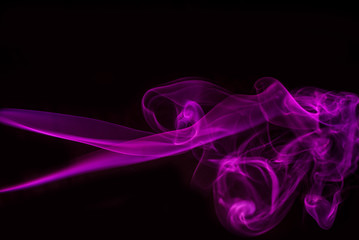 Obraz na płótnie Canvas Abstract colored smoke isolated in black background