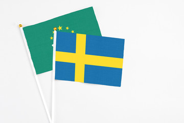 Sweden and Macao stick flags on white background. High quality fabric, miniature national flag. Peaceful global concept.White floor for copy space.