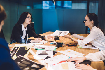 Diverse businesswomen working in team at table
