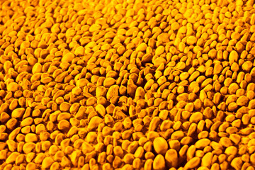 Abstract golden orange background with texture of small round stones