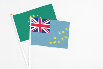 Fototapeta premium Tuvalu and Macao stick flags on white background. High quality fabric, miniature national flag. Peaceful global concept.White floor for copy space.