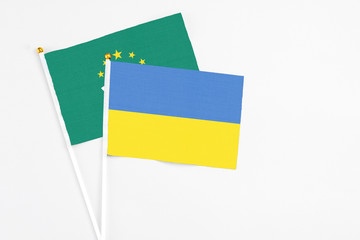 Ukraine and Macao stick flags on white background. High quality fabric, miniature national flag. Peaceful global concept.White floor for copy space.