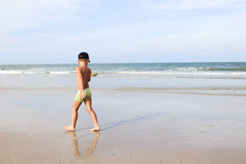Close up of Men's back of Young men in front of the sea and beach