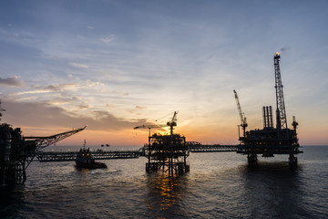 Fototapeta na wymiar Silhouette of oil production platform at oil field