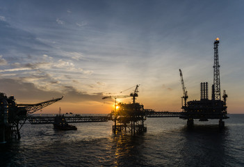 Fototapeta na wymiar Silhouette of oil production platform at oil field