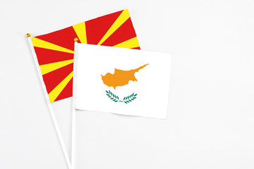 Cyprus and Macedonia stick flags on white background. High quality fabric, miniature national flag. Peaceful global concept.White floor for copy space.