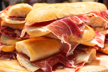 Spanish street food bocadillo fresh bread with jamon iberico ready to eat