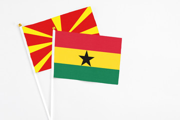 Ghana and Macedonia stick flags on white background. High quality fabric, miniature national flag. Peaceful global concept.White floor for copy space.