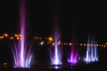 Ukraine. Kyiv - 05.06.2019 Amazing dancing fountain in the night illumination of rainbow color with colorful illuminations on the lake.