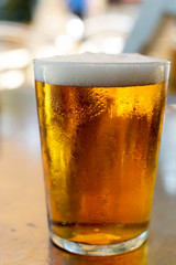 Cold amber color light spanish beer served in glass in outdoor cafe in sunny Andalusia, Spain