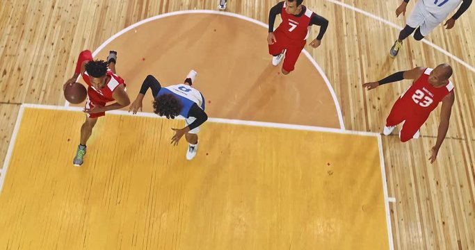 Drone footage of basketball players on big professional arena during the game. Tense moment of the game. Celebration