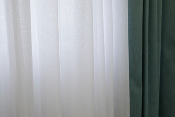 Fabric blue curtains and white tulle. Abstract background, drapes fabric on curtain rod