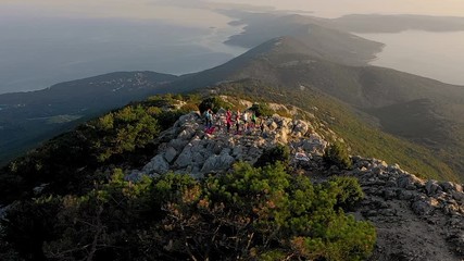 Aerial view of group practicing yoga at top of mountain, Veli Lošinj, Croatia.