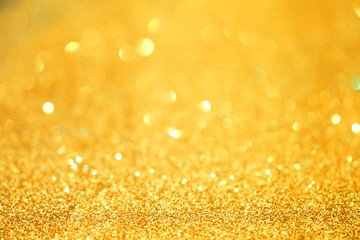Luxury gold glitter with bokeh background, de-focused.