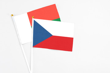 Czech Republic and Madagascar stick flags on white background. High quality fabric, miniature national flag. Peaceful global concept.White floor for copy space.