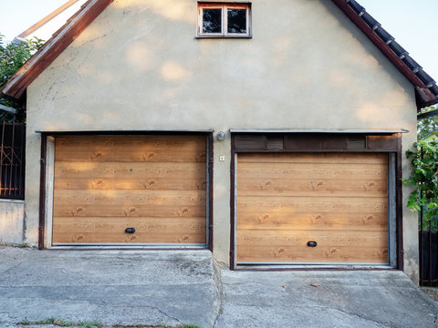 Facade of a garage with two gates wood trim