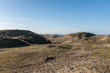 Dune landscape with a sea view between the dune tops