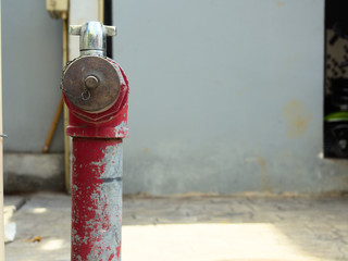 Old fire hydrant on the street in Thailand, with a threaded connection to connect the fire hose