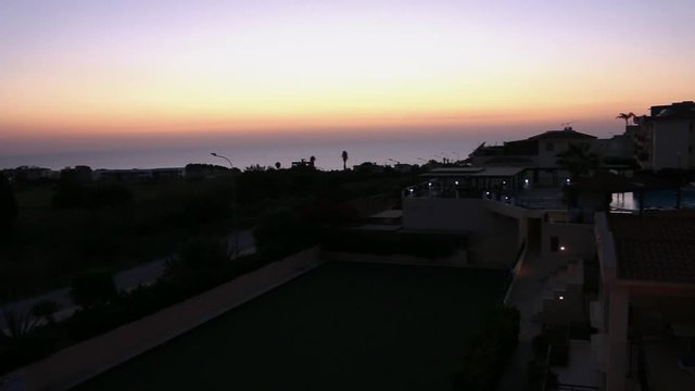 Pan sunset winter solstice horizon view of the coastal town of Paphos Cyprus.
