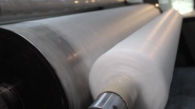 Rolls of non-woven fabric are being pushed into the tube. Nonwoven fabric production