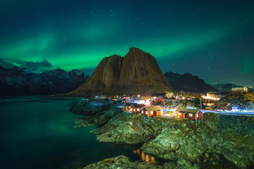 northern lights at norwegian lofoten town - obrazy, fototapety, plakaty