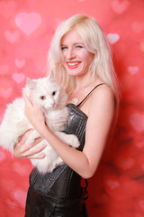 young attractive girl with lovely adult cat on studio background