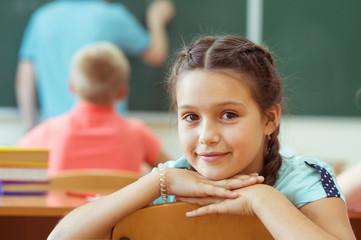 Cute smiling schoolgirl at school