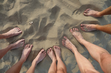 ten feet of family of five on the sandy beach