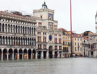 Naklejka premium Saint Mark Square in Venice during the tide and the ancient Cloc