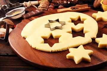 Baking christmas cookies. Typical cinnamon stars bakery with spices. xmas decoration on table