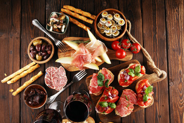 Italian antipasti wine snacks set. Cheese variety, Mediterranean olives, seafood salad, Prosciutto...